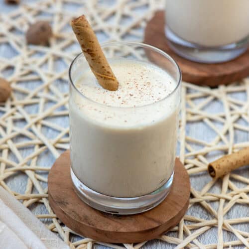 Frozen Brandy Alexander in a lowball glass with fresh grated nutmeg on top and a Pirouette cookie as a stir stick